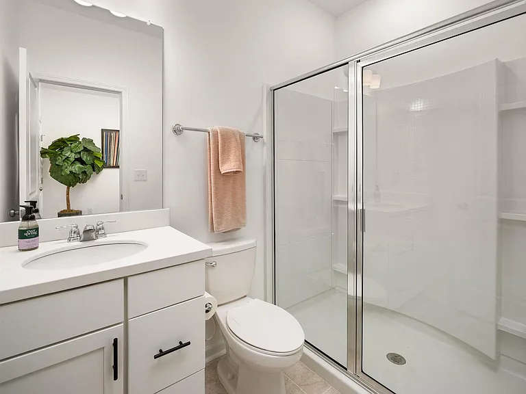Stylish third bathroom featuring a vanity and walk-in shower.