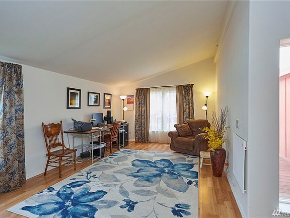 Living room / sitting room / office area with vaulted ceilings at the entry side of home