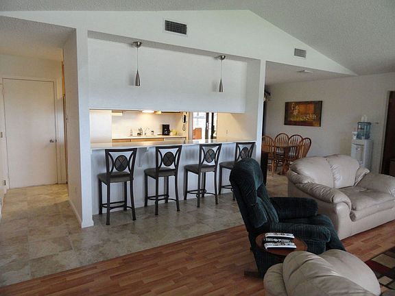 Kitchen open to living and dining room with a breakfast bar