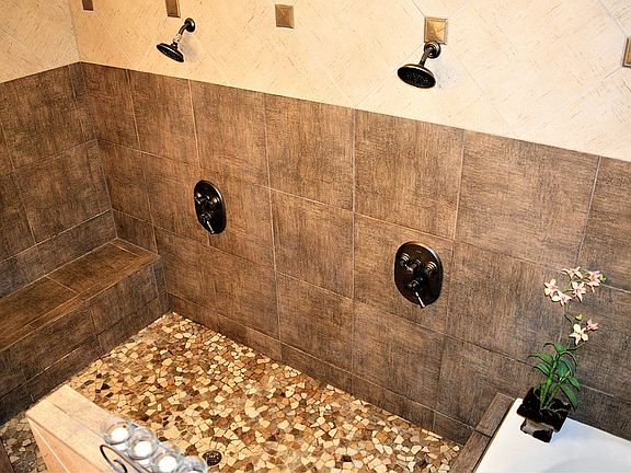 Pebble floor. Shower bench