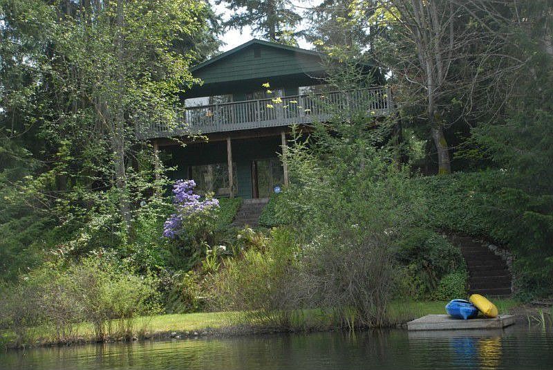 Viewed from the lake, this home is nestled among the trees and embraces nature.