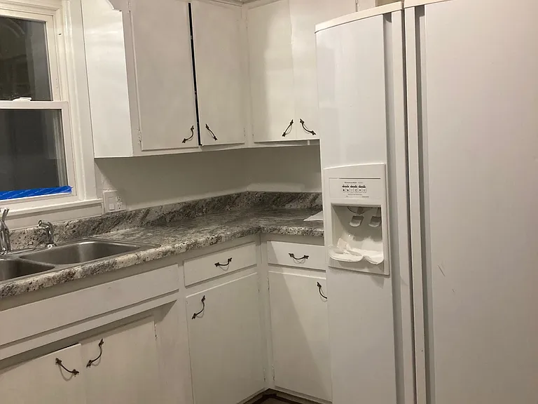 Kitchen with side by side refrigerator.
