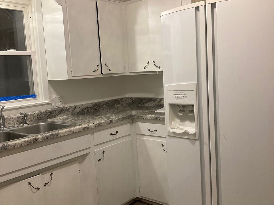 Kitchen with side by side refrigerator.