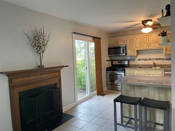 Kitchen includes a fireplace and patio access