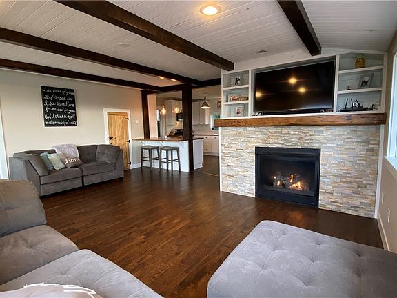 Cozy family room with propane fireplace and shiplap ceilings.
