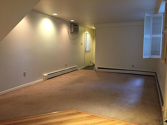 Photo taken form the kitchen looking back into the living room. Entry hall and door is at the opposite corner.