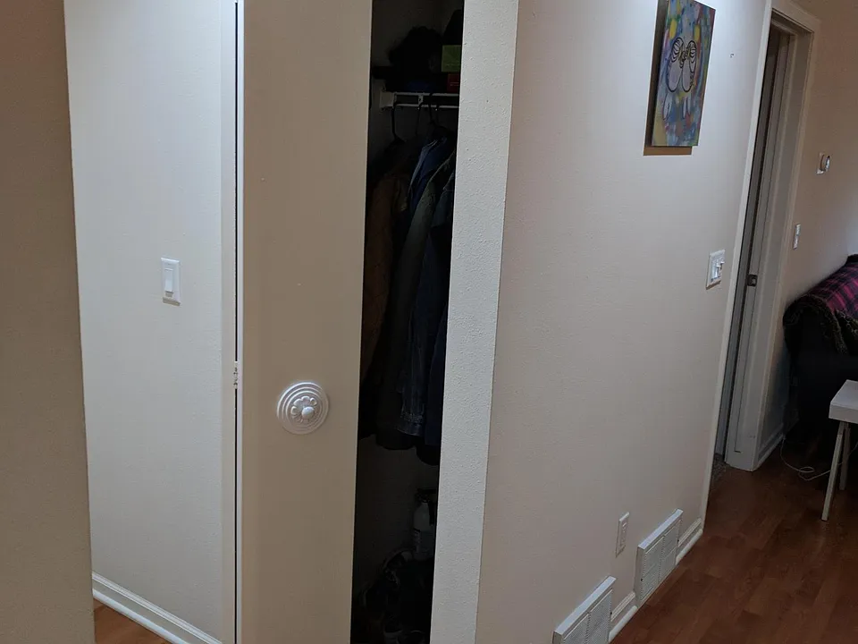 Coat closet near condo's entry.