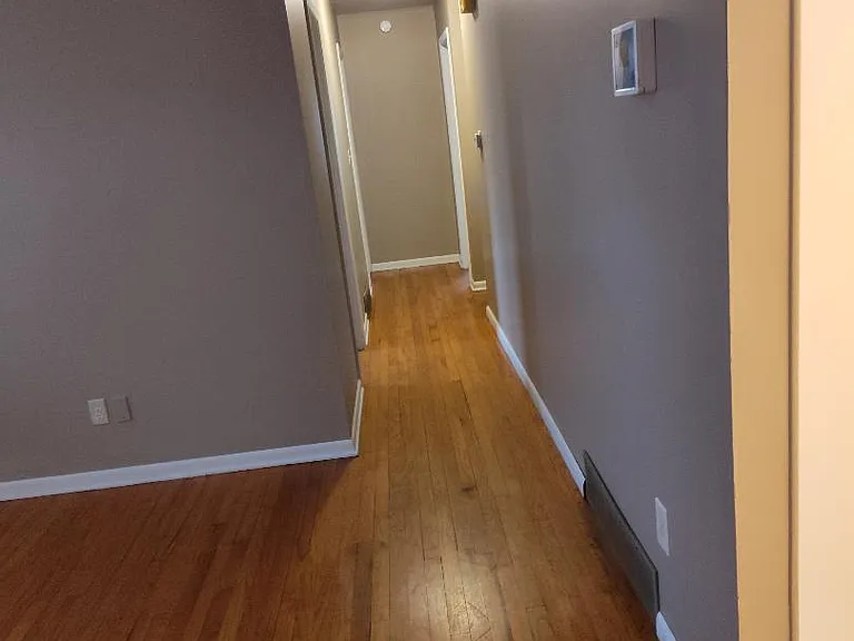 Hallway to bathroom and three bedrooms