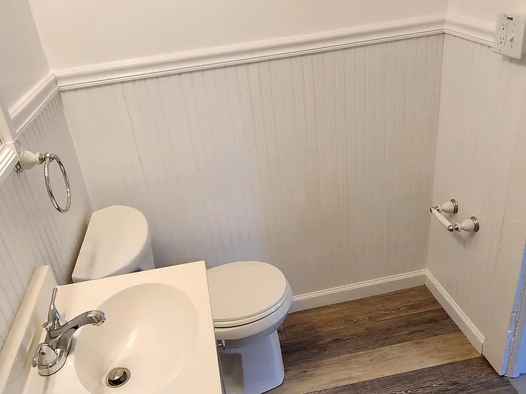 Wall showing towel bar. Another tower bar tower has been added on inside of bathroom door.