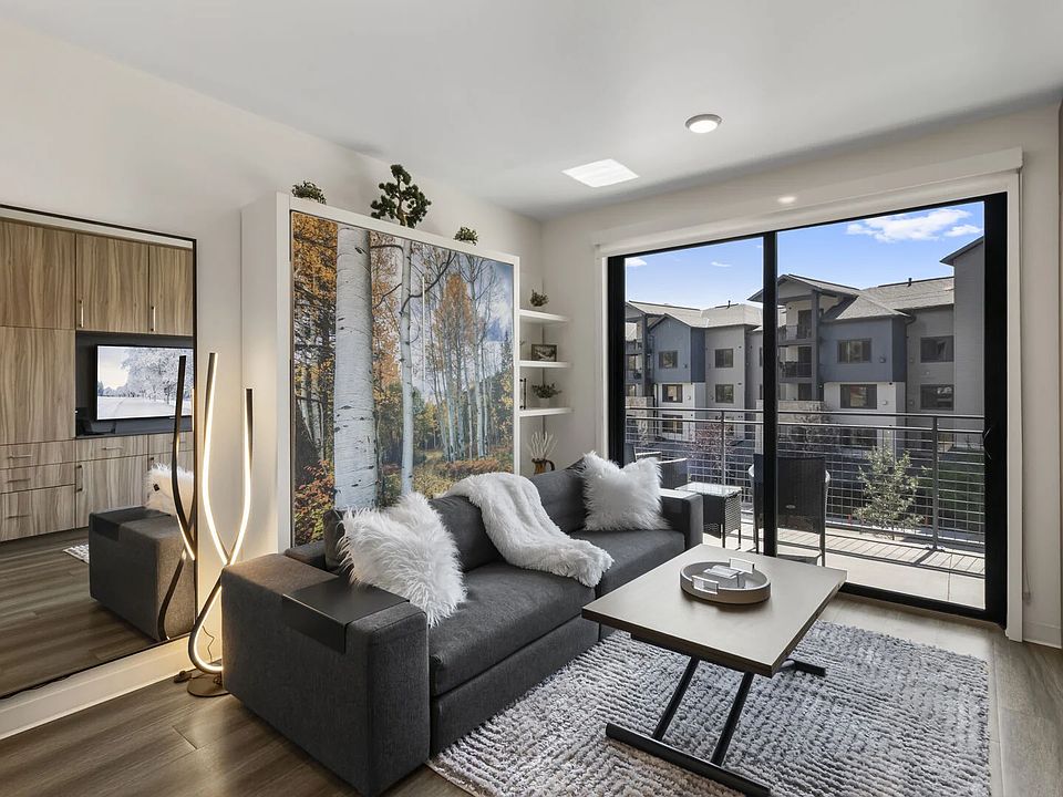 Studio living area with queen Murphy bed and balcony