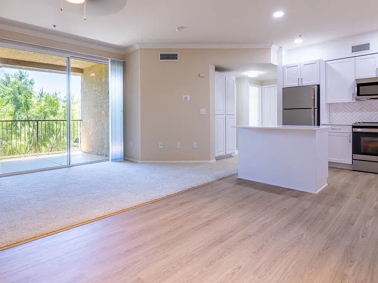 Carpeted Living Room with Balcony