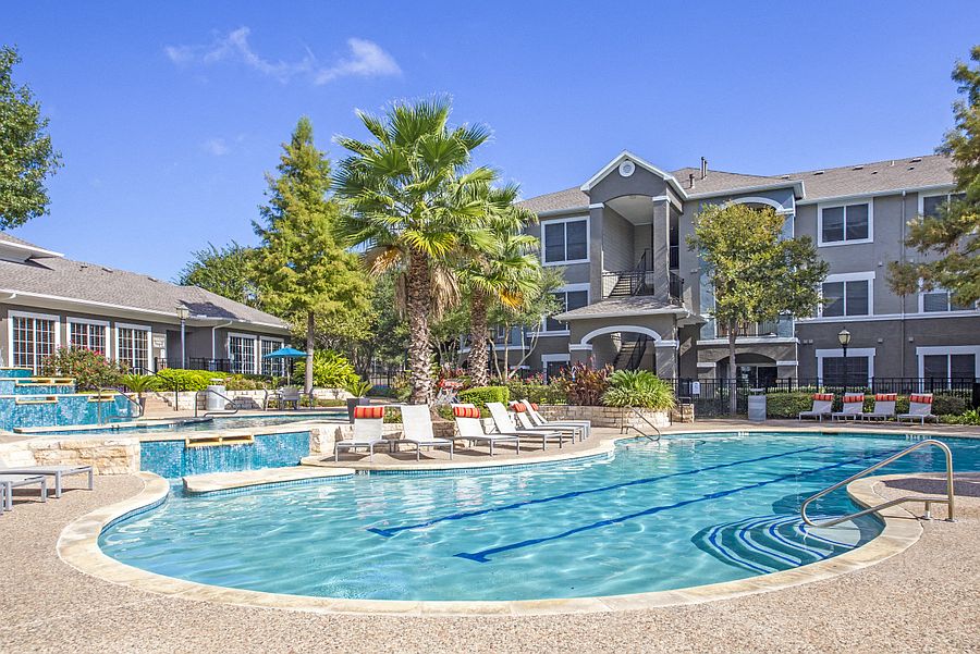 Austin, TX Apartments - Exterior View of Nolina Flats Apartments Building Surrounded By Lush Landscaping with Views of the Pool