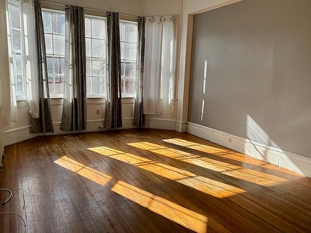 Sun-filled Living Room with wonderful windows and hardwood floors.