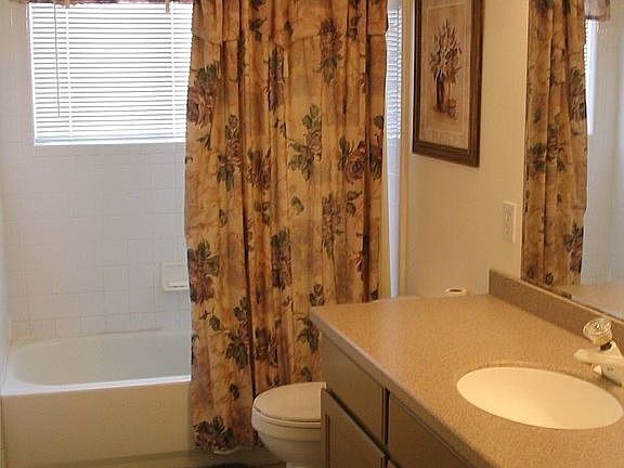 main floor bath with large window and ceramic tile