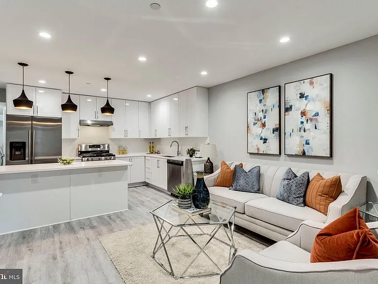 Open-concept living and kitchen area with modern finishes and recessed lighting
