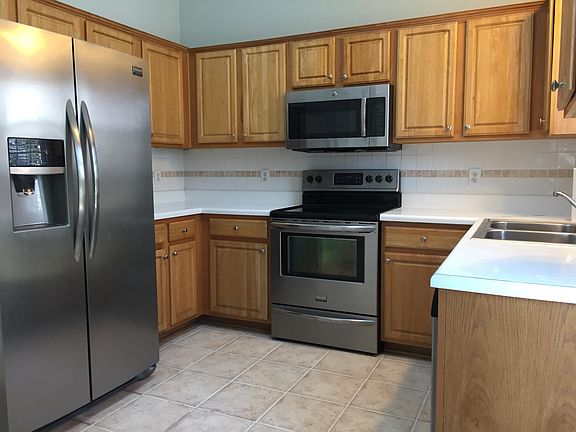 Kitchen with ceramic tile floor, stainless appliances, and cathedral ceiling.