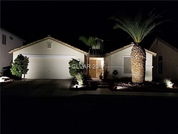 Front and rear landscape lighting show off this beautiful home.