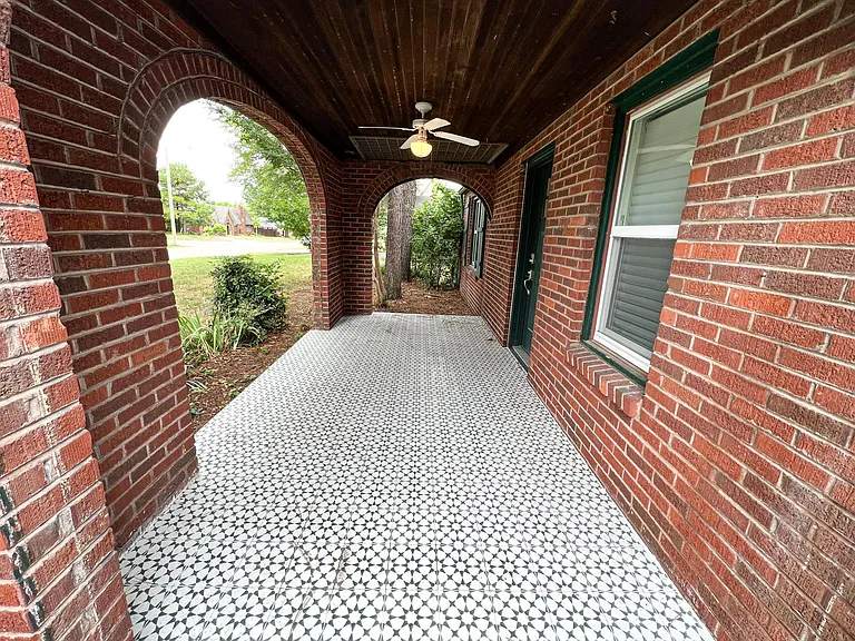 Large covered front porch with matching estrella green tile
