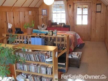 Large master bedroom : With built in shelves, closets lining each wall, and washer dryer.