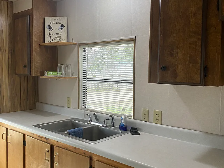 Kitchen window looks out into front yard.