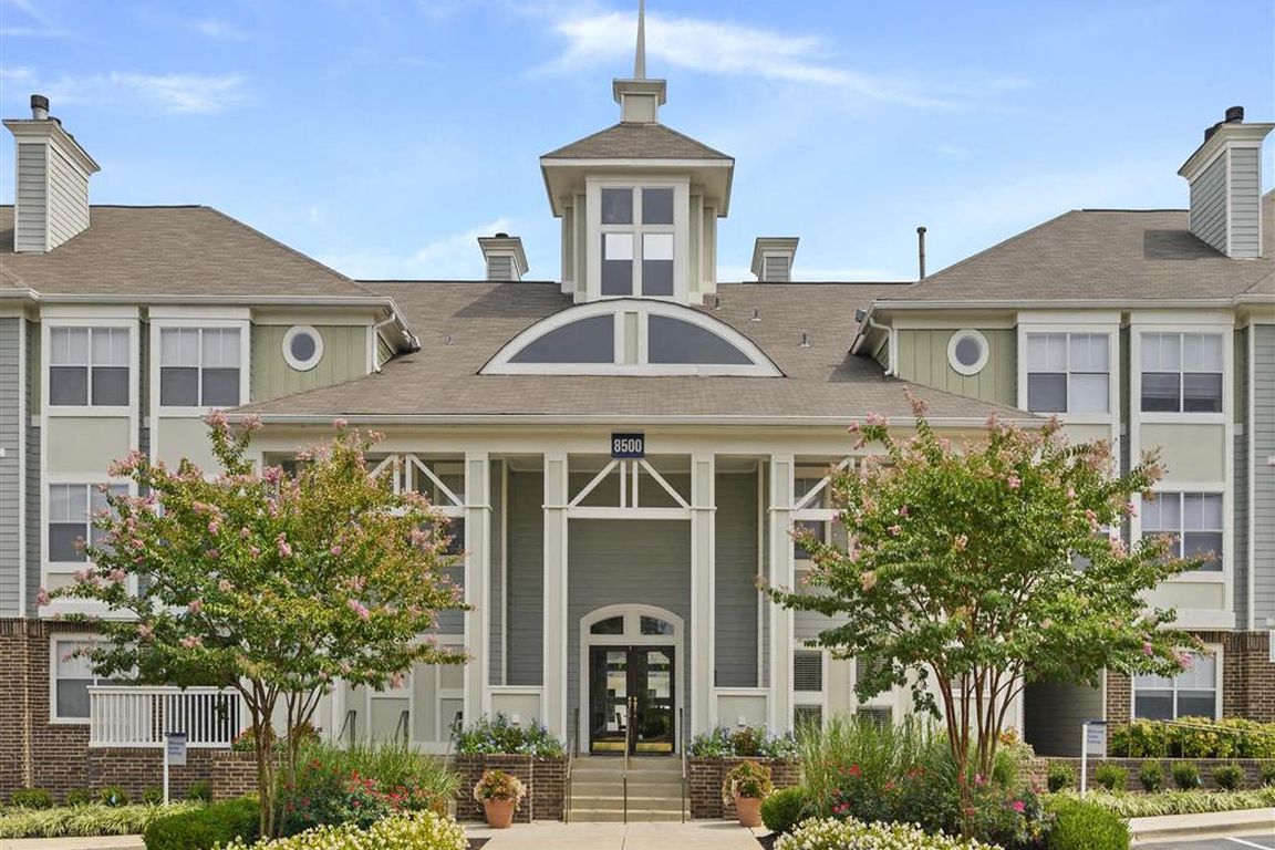 Elegant entrance with classic architectural details and manicured landscaping.