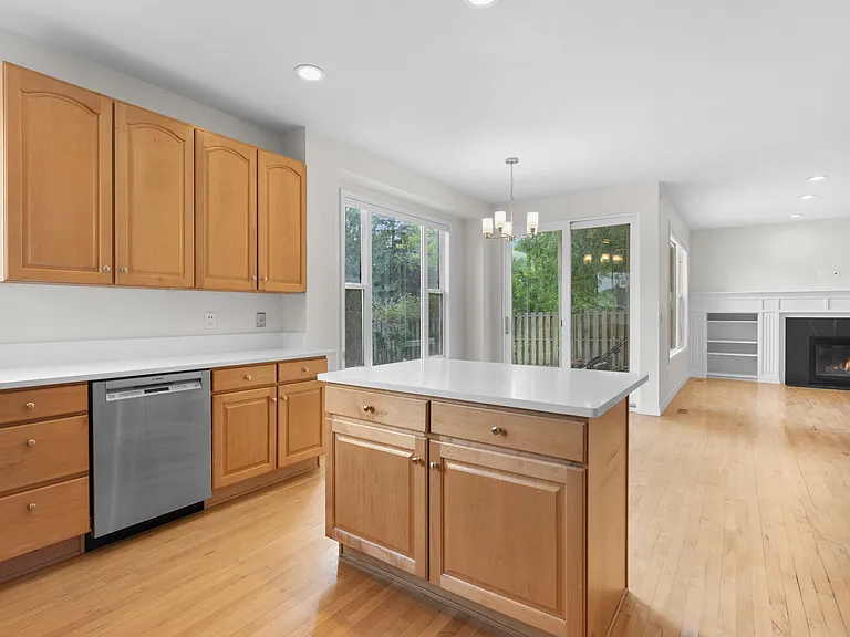 The kitchen island provides additional storage space and flexible seating options for casual dining or entertaining.