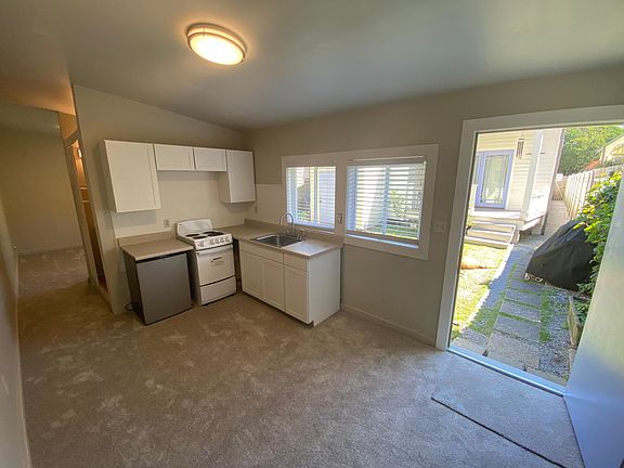 Entrance door and kitchen, all new paint, carpet, cabinets, etc.