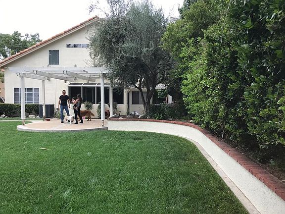 Another backyard view from the far opposite corner. Dogs are not included in the rental.