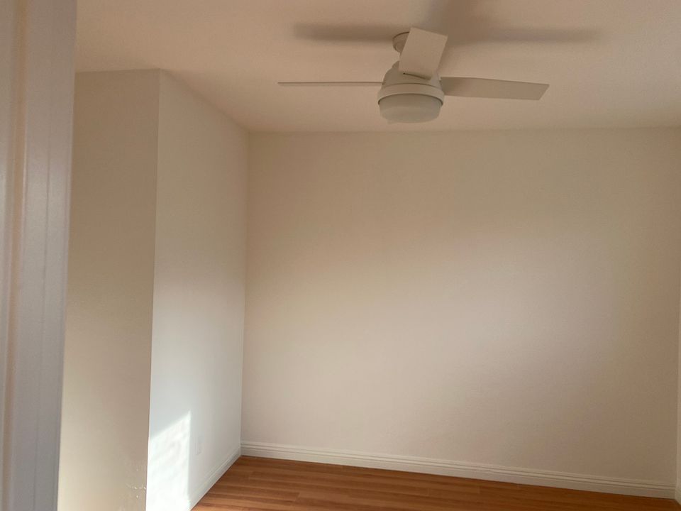 Ensuite second bedroom with ceiling fan and half bath