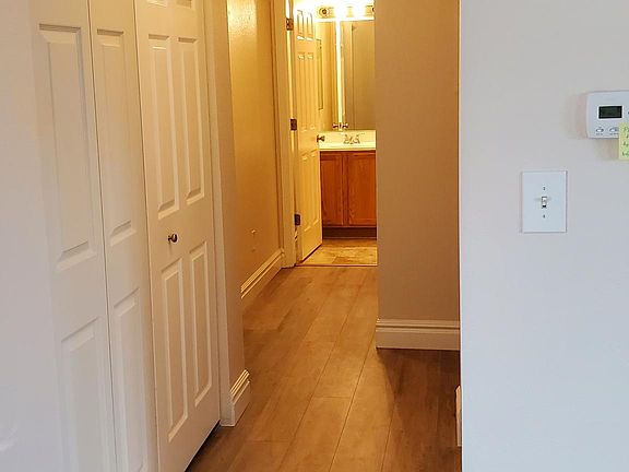 Hallway with laundry room closet on left