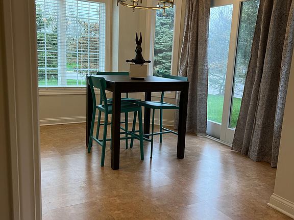 Breakfast/eat-in kitchen area transitions to large kitchen and outdoor patio