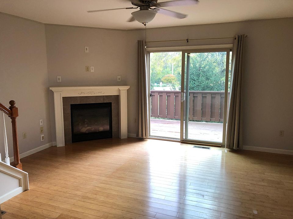 Living room with gas fireplace and rear deck.