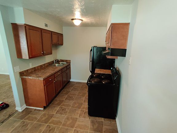 Kitchen with refrigerator and stove included.