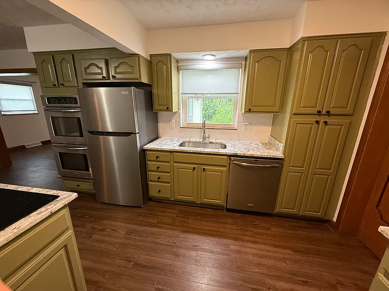 Newly renovated kitchen with all appliances including new range, double oven, dishwasher and microwave oven