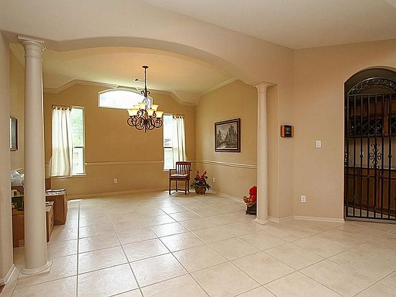  Formal dining room with columns providing a sophisticated frame- and close proximity to the wine room!