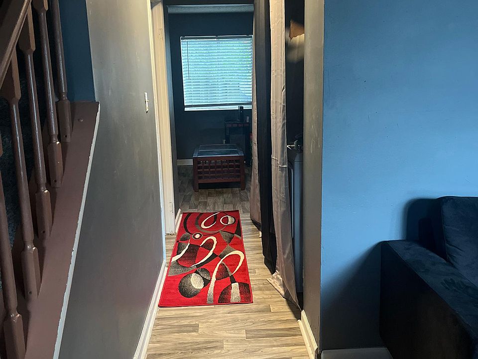 Hallway leading to lounge area past 1/2 bathroom and laundry area