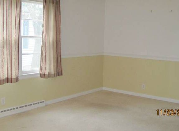 Large living room, hardwood under the carpet.