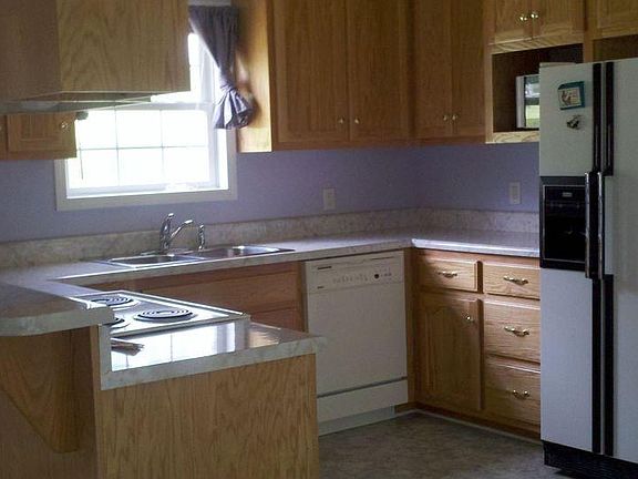 Large kitchen with dishwasher, refrigerator (as is), microwave, stove, & oven