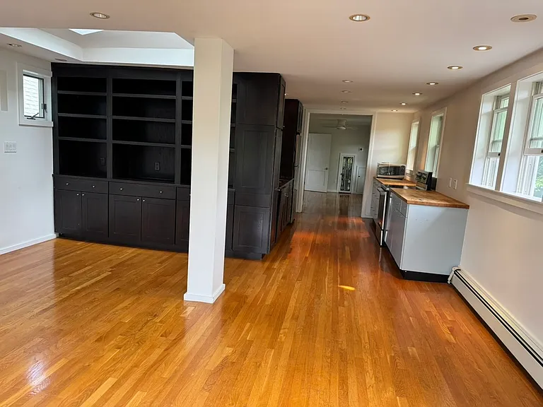 Living room, then kitchen, and room at the end is one of the two bedrooms.