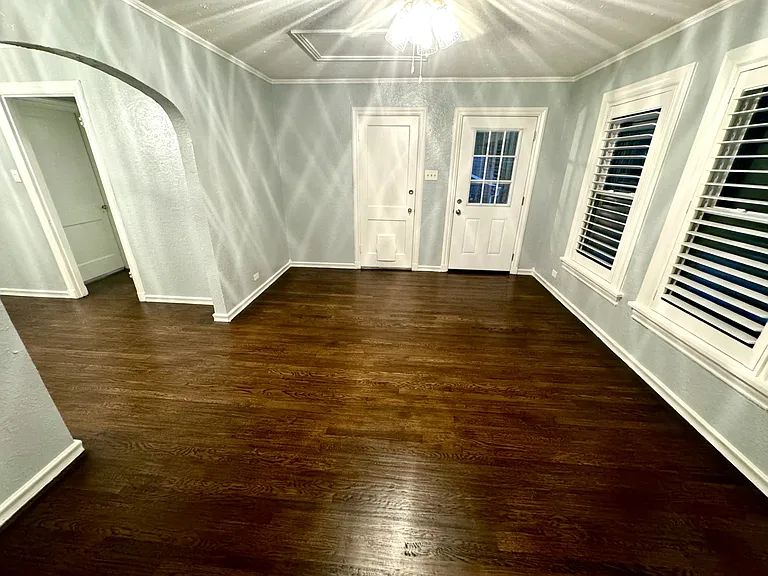 View from the feaux fireplace, looking out at the private porch (on the right) and the door (left) leading downstairs to the front door entrance.
