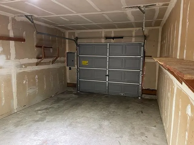 Garage has automatic garage door installed with remote