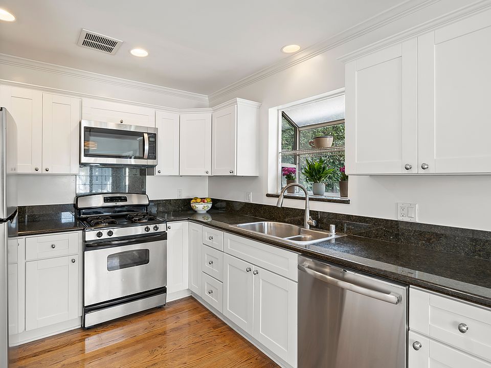 KITCHEN WITH ALL MODERN STAINLESS STEEL APPLIANCES, SINK AND SPRAY FAUCET