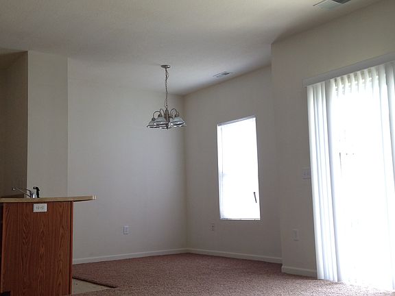 Open concept dining/living area w/sliding glass door to pati