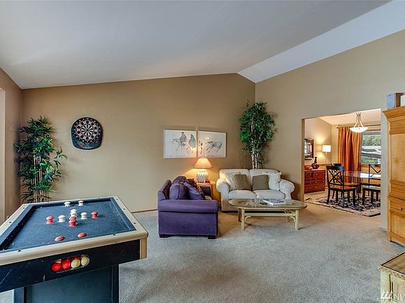 The living room is spacious and features vaulted ceilings.