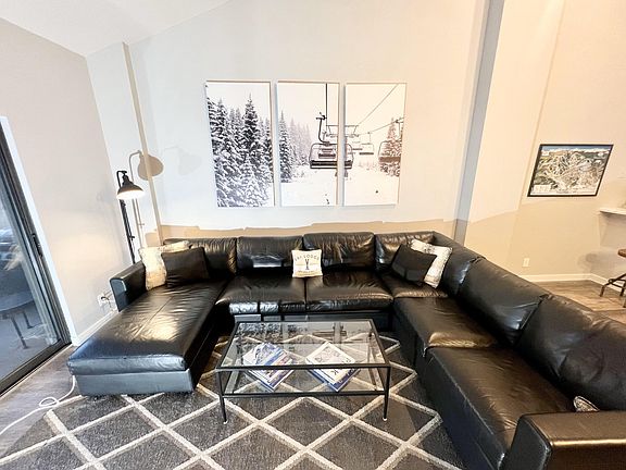 Living room with large sofa-bed sectional and storage chaise lounge, 65 in LED TV, fireplace, balcony with grill and sweeping views of Beaver Creek mountain