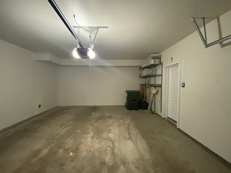 Large 2 car garage with storage shelves