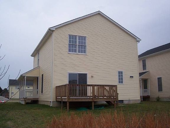 Back of home with deck