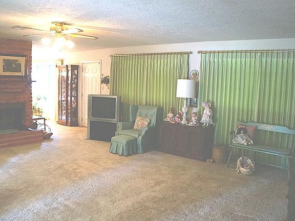 View of the large family room with a cozy wood burning fireplace.