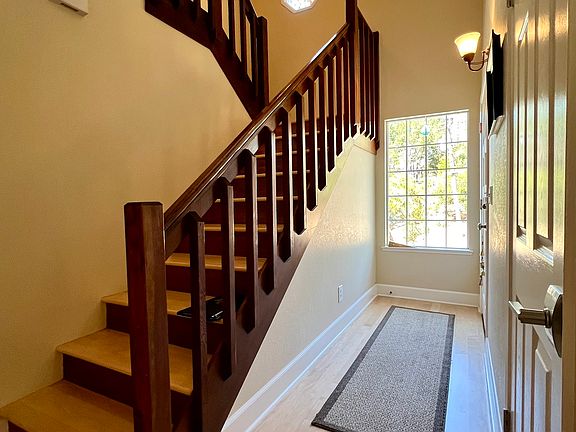 Looking toward the front door entrance. Stairs to upstairs primary suite