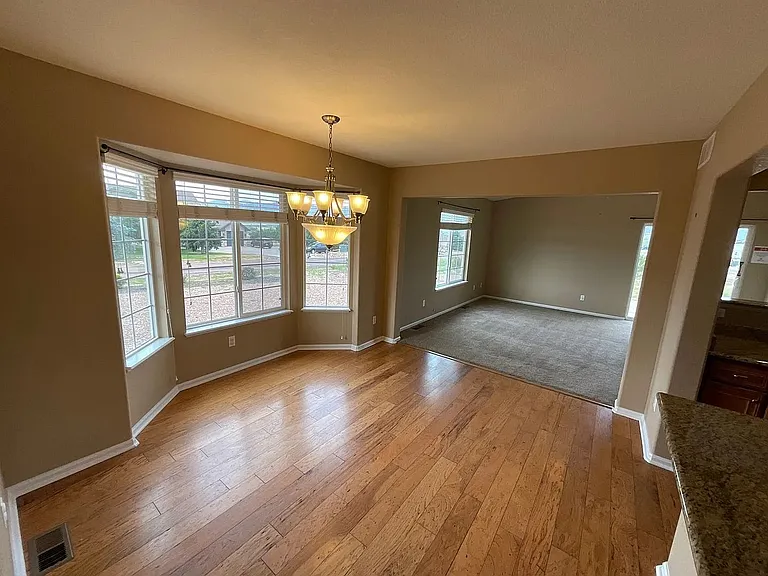 Beautiful dining space with natural bay windows and hardwood floors!